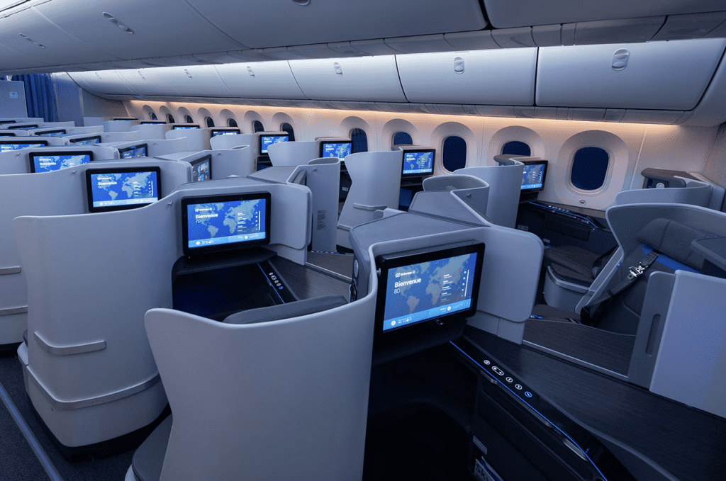 Modern airline business class seats with in-flight entertainment screens at Globalia Corp. | Luxury travel experience.