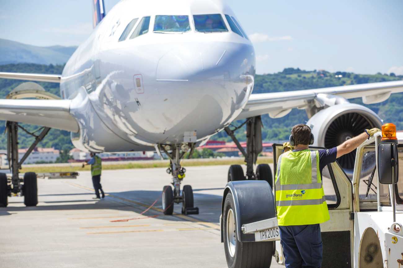 Aircraft ground crew preparing airplane at airport runway, aviation, airport operations, flight logistics.