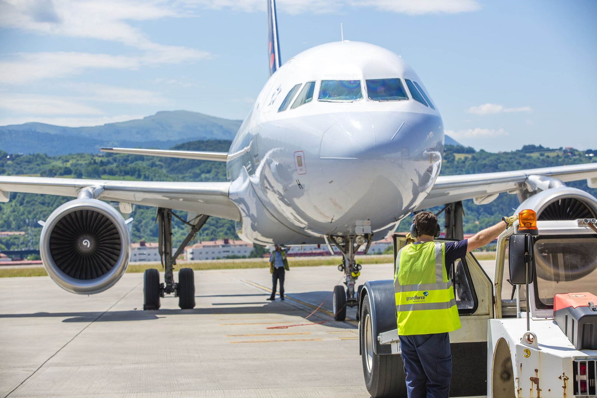 Jet aircraft on tarmac during ground handling at airport.