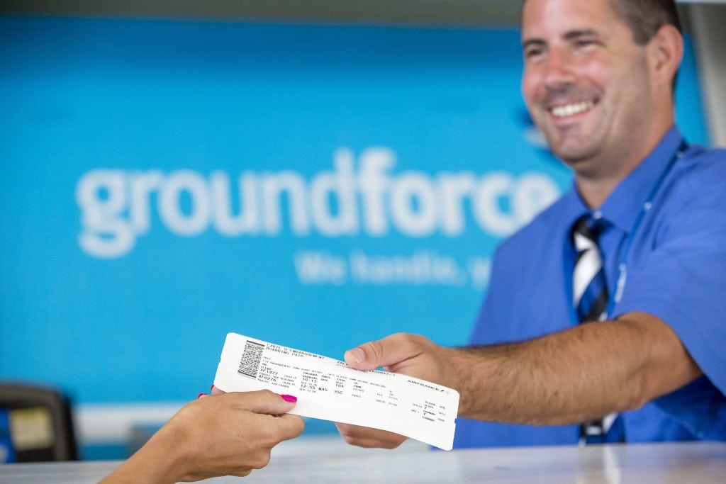 Boarding pass being handed over at Groundforce, airline services and travel assistance.