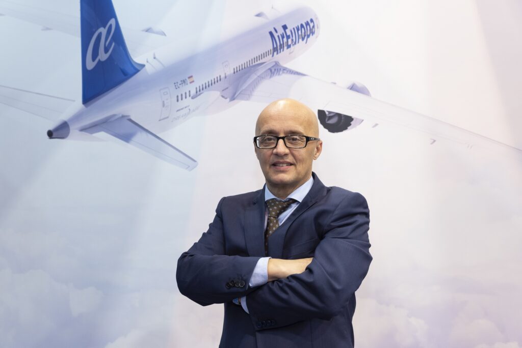 Boeing airplane with Globalia branding and a business executive in front at an aviation event.