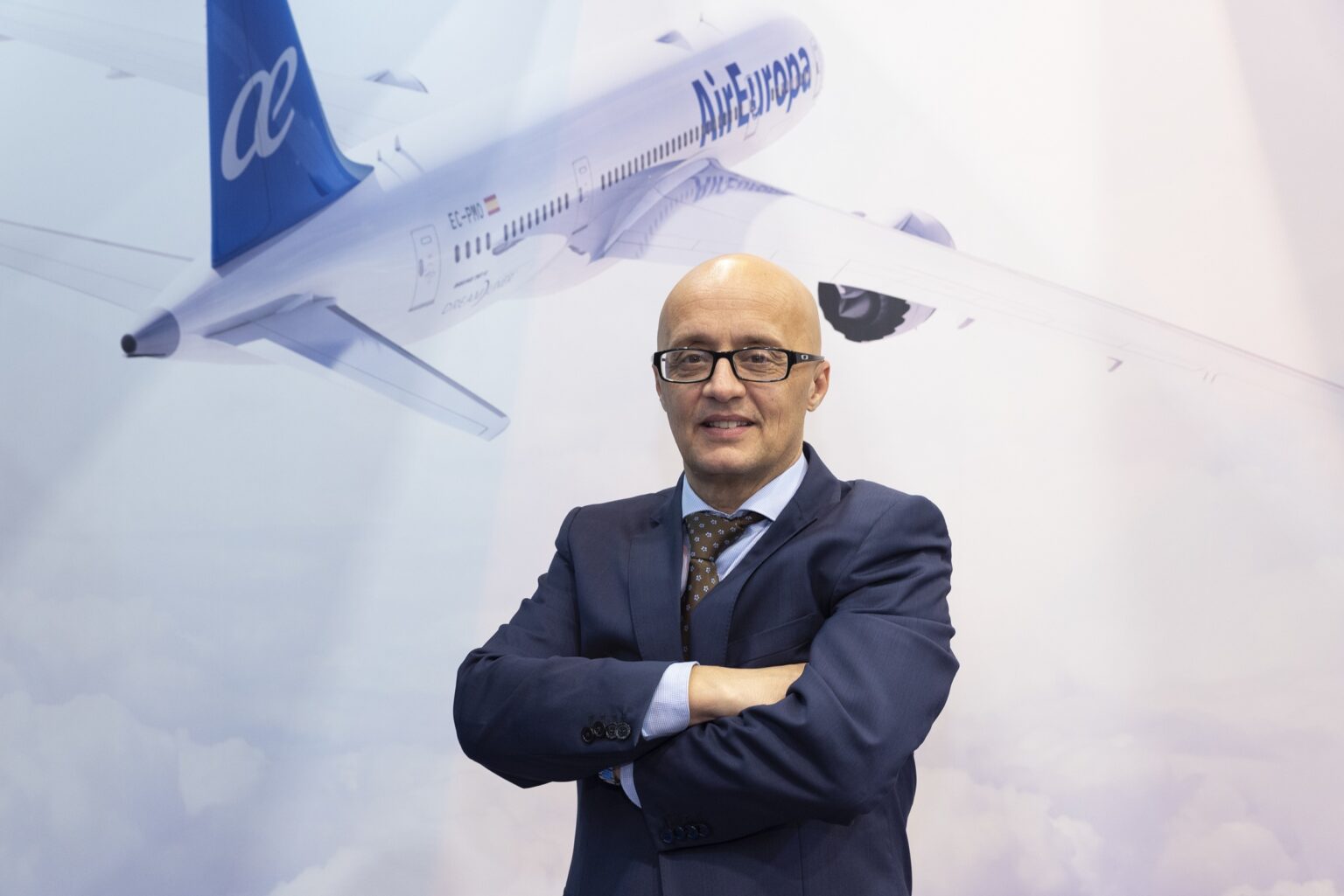 Boeing airplane with Globalia branding and a business executive in front at an aviation event.